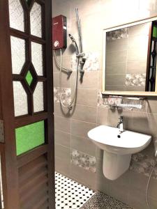 a bathroom with a sink and a mirror at Le Meilleur Classic L Bangkok and Modern Wing is at no 3 Jln Yeoh Guan Seok in George Town