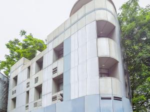 a white building with balconies on the side of it at Super Collection O Hotel Pearl Near Shaniwar Wada in Pune