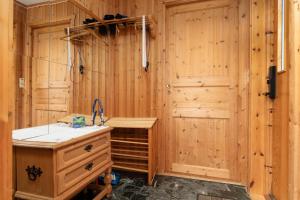 a room with a wooden wall with a wooden desk at Bestefarhaugen - The cozy house on the hill - with a dome in Bø