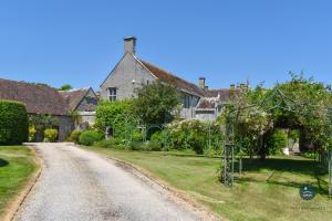 an empty road in front of a house at Poxwell Manor West Wing - Exclusive Dorset Retreat 