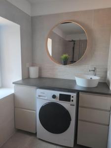 a bathroom with a sink and a washing machine at BOHO location 1 in Bonnieux