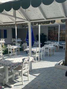 a group of tables and chairs under an umbrella at OTEL A in Çeşme