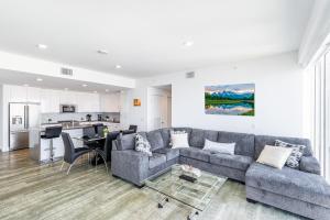 a living room with a couch and a table at Top Floor High Rise 3 Bed DTLA Skyscraper Penthouse in Los Angeles