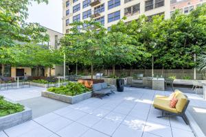 a patio with furniture and trees in a building at Top Floor High Rise 3 Bed DTLA Skyscraper Penthouse in Los Angeles