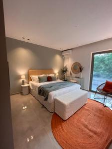 a bedroom with a large bed and a large window at O live Kalamata in Kalamata