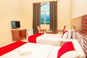 Postel nebo postele na pokoji v ubytování Al Jabal Hotel