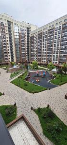a large apartment building with a playground in front of it at ЖК Арбат в самом центре города in Almaty