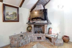 a living room with a stone fireplace with a mirror at Hotel PERLA LESKOVAC in Leskovac