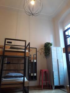 a room with bunk beds and a mirror and a chandelier at 5 Terre Backpackers City in La Spezia