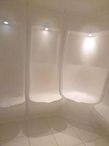 two urinals in a bathroom with white walls at T2 Les Chardons avec Piscine Sauna et Hammam in Valloire