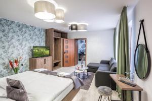 a bedroom with a bed and a couch at Hotel Beta in Bzenec