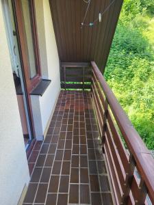 a walkway leading to the porch of a house at Rooms MARETČ in Bohinj