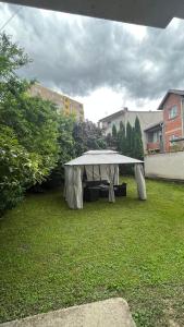 a white tent sitting in a grass field at ALOHA apartment in Novi Pazar