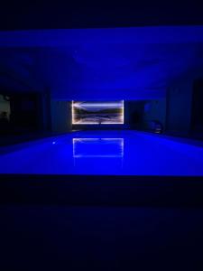 a blue room with a bath tub in a room at Casa Bucatarului in Bălnaca +22 photos