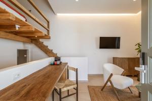 a living room with a wooden table and chairs at Aya Sofia Suites in Mýkonos City