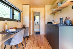 a kitchen with a counter and chairs in a room at Secluded Offgrid Cabin w/ Sunset View & Fireplace in Canterbury