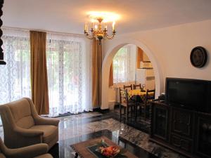 a living room with a chandelier and a dining room at Zrínyi ház in Szántód