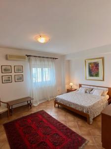 a bedroom with a bed and a red rug at BellaVista Apartments in Taormina