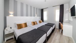 Кровать или кровати в номере Motto Premium Hotel&Spa