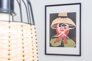 a painting of a woman in a hat on a wall at Eslanzarote ECO TANA HOUSE, super wifi, Tv satélite, Bbq in Playa Honda
