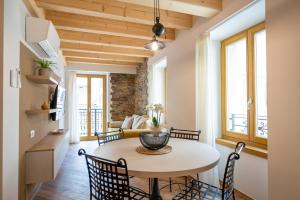 a kitchen and living room with a table and chairs at La Fontanella - Holiday Apartments in Arco