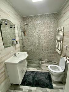 y baño con aseo blanco y lavamanos. en Cosy place to stay, en Timisoara