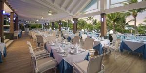 a banquet hall with white tables and chairs at Your Home Away From Home in San Felipe de Puerto Plata