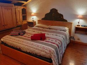 a bedroom with a large bed with two pillows on it at La Mansarda in the Dolomites Jacuzzi in Santo Stefano di Cadore