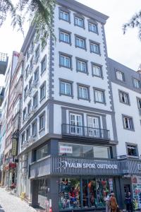 a tall white building on a city street at MELL City Hotel Trabzon in Trabzon