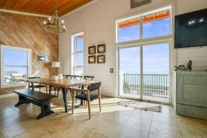 a dining room with a table and a view of the ocean at Stairway to Heaven Hot Tub Beach Retreat in Flagler Beach