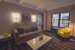 a living room with a couch and a table at Hotel Edison Times Square in New York