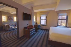 a hotel room with a bed and a television at Hotel Edison Times Square in New York