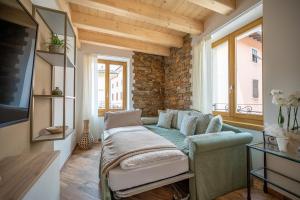 a living room with a couch and a window at La Fontanella - Holiday Apartments in Arco