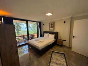 a bedroom with a bed and a balcony at LexiaDeluxeSuit in Sapanca +13 photos