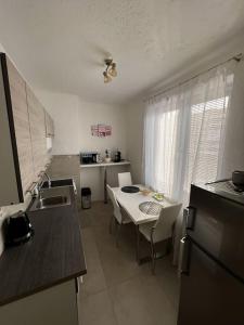 a kitchen with a table and a white table and chairs at Modern, Cozy apartment with Netflix & Free parking 