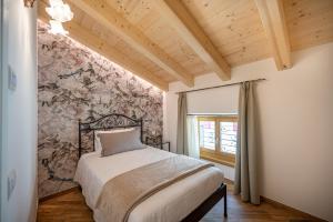a bedroom with a bed and a floral wall at La Fontanella - Holiday Apartments in Arco