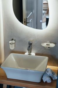 a bathroom sink with a large mirror above it at Armonia Villa Serifos in Rámos +21 photos