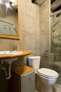 a bathroom with a toilet and a sink at Casa Biax jardín y terraza privada junto al mar in Ea