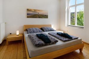 a bedroom with a bed with two pillows on it at Villa Fokken Kapitänsquartier in Esens
