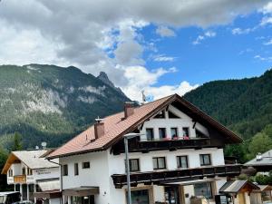 a building with people on a balcony in the mountains at Weidach Zentrum in Leutasch