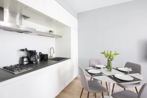 a kitchen and dining room with a table and chairs at Beautiful 2BD near Times Square with Doorman and Gym in New York