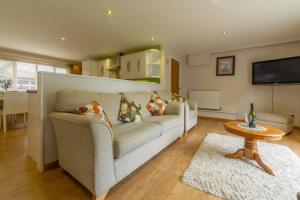 a living room with a couch and a table at Southview Annexe in Sculthorpe