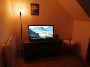 a television sitting on a stand in a room at Central Sligo Townhouse in Sligo +12 photos