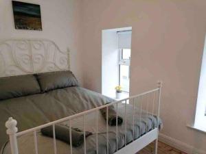 a bedroom with a bed with a white bed frame at Central Sligo Townhouse in Sligo