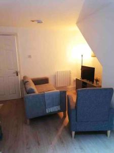 a living room with a couch and a chair at Central Sligo Townhouse in Sligo