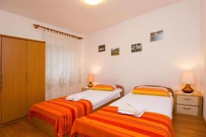 Posteľ alebo postele v izbe v ubytovaní Apartments Marlen