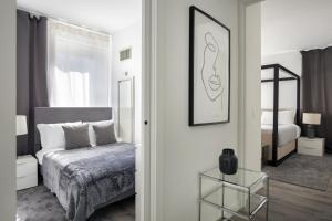 a bedroom with a bed and a mirror at Cozy 2BD near Times Square with Doorman and Gym in New York