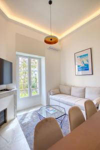 a living room with a couch and a tv at LimeSTAY - The Cannois T2 Modern WIFI in Cannes