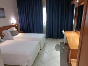 Postel nebo postele na pokoji v ubytování Green Hotel Ninfa