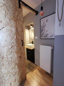 a bathroom with a stone wall and a sink at RIVER HOUSE in Bardo